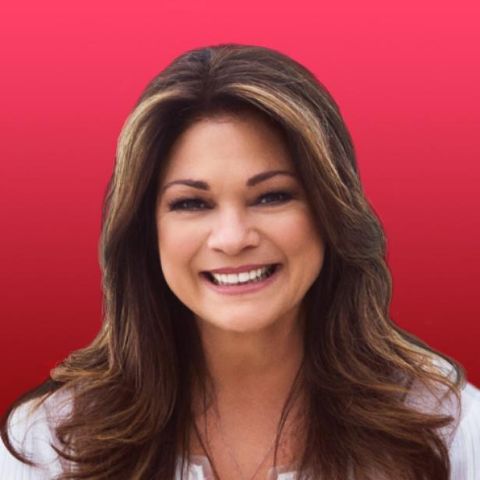 Valerie Bertinelli in a white top poses for a picture.